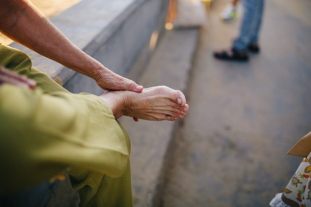 Medical Marijuana patient rubbing foot hurting from Neuropathy